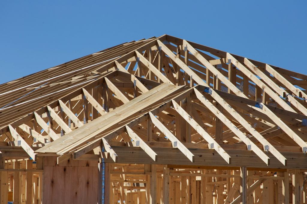 Timber roof framing on a house under construction (illustrative)
